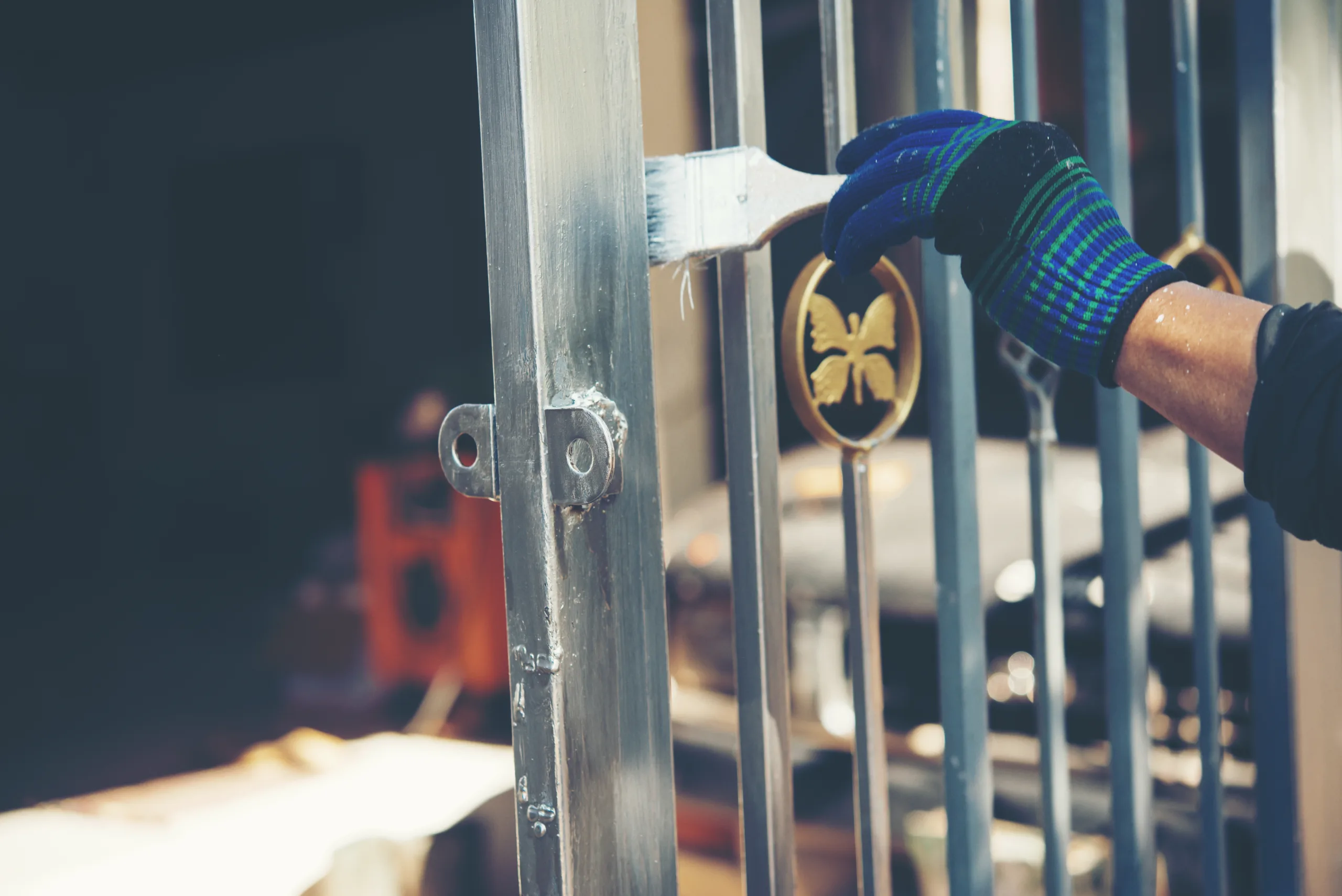 Construction worker painting fence at home, closeup pintu besi
